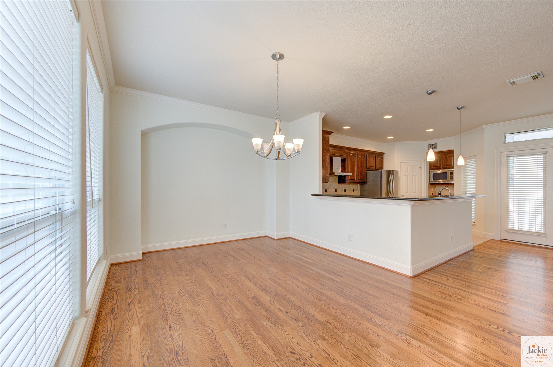 1322 Cohn Street Houston, TX 77007 - Photo 8 of 30 a view of a kitchen with wooden floor and a ceiling fan