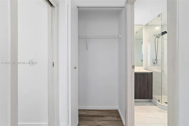 a bathroom with a shower sink mirror and toilet