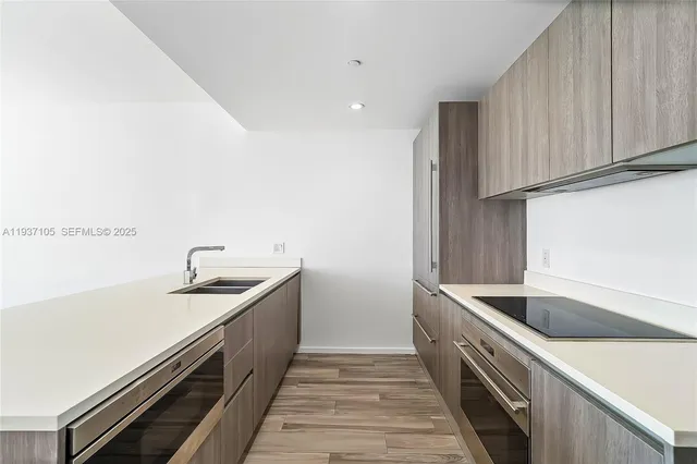 a kitchen that has a sink and a stove