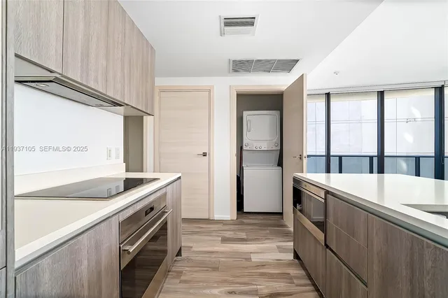 a kitchen with granite countertop a sink and a stove