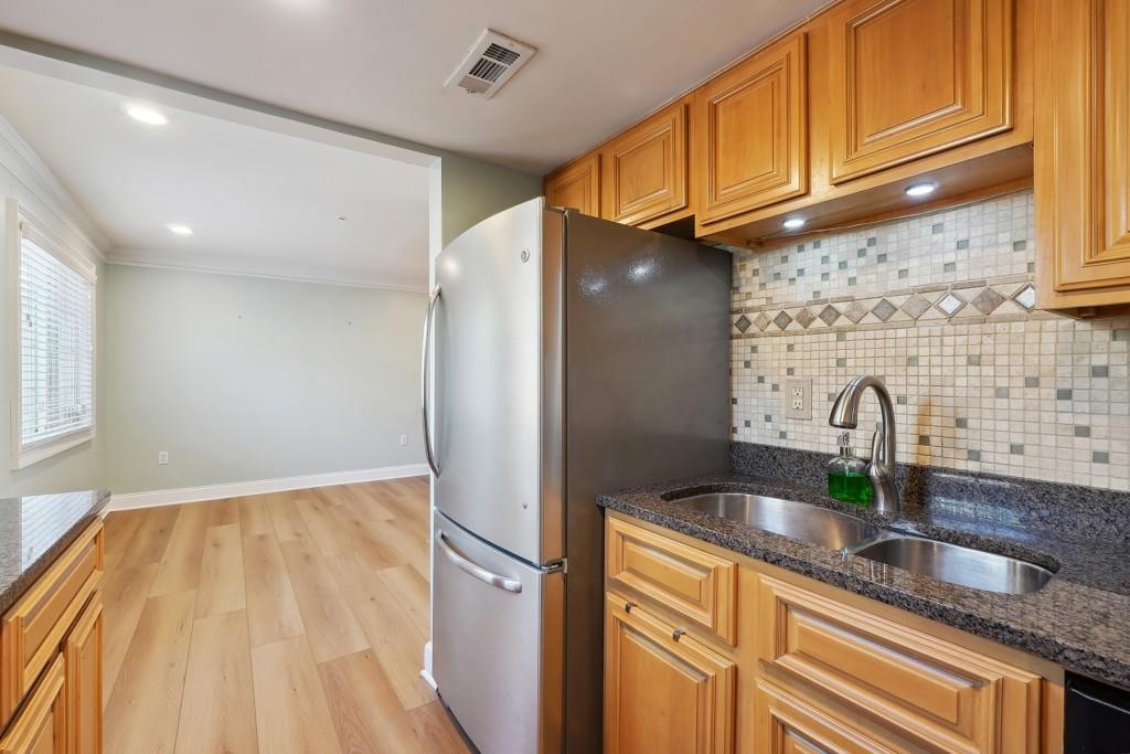 104 Rondak Circle Smyrna, GA 30080 - Photo 12 of 33 a kitchen with granite countertop a sink a refrigerator and counter space