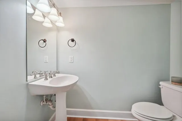 a bathroom with a sink a mirror and a toilet