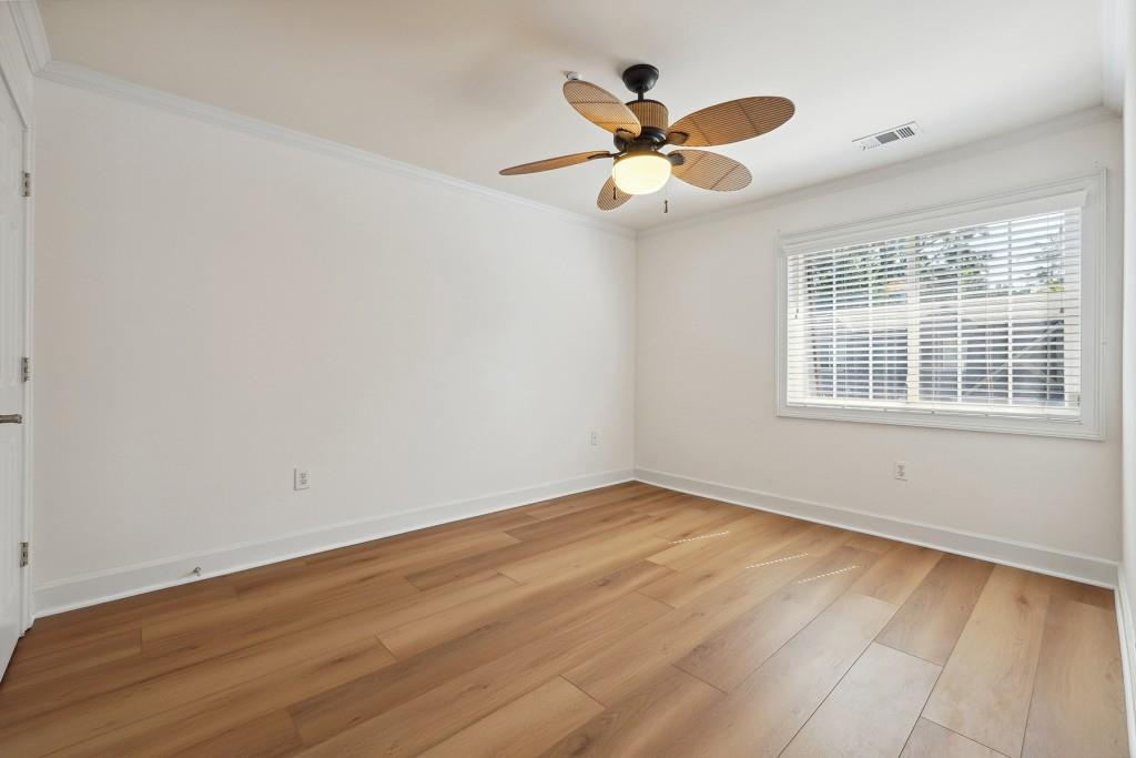 104 Rondak Circle Smyrna, GA 30080 - Photo 21 of 33 a view of a big room with wooden floor a ceiling fan and windows