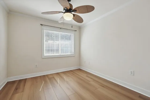 wooden floor in an empty room with a window