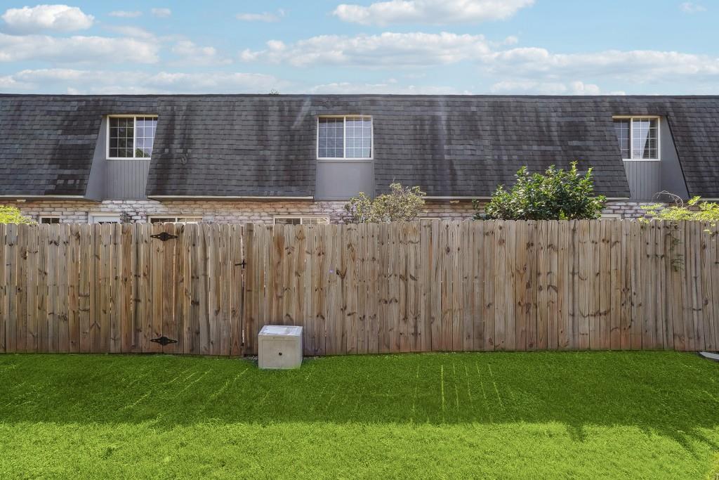 104 Rondak Circle Smyrna, GA 30080 - Photo 26 of 33 a view of a brick house with a wooden fence