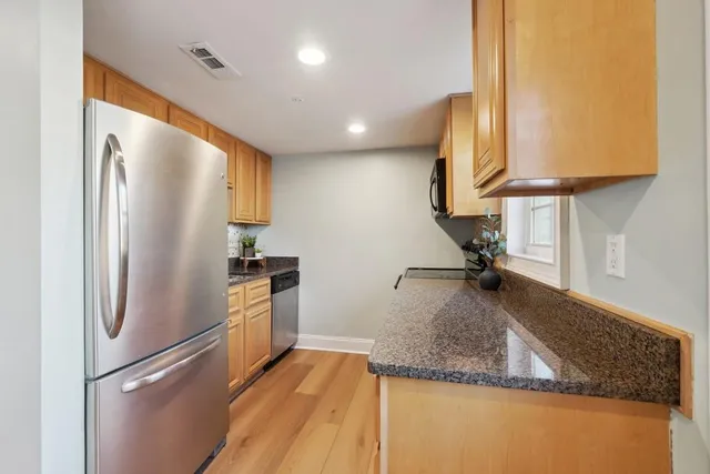 a kitchen with a refrigerator sink and stove