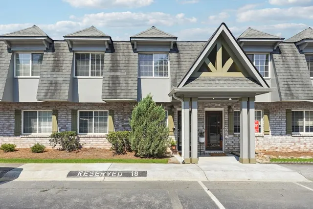 a front view of a house with a garden and plants