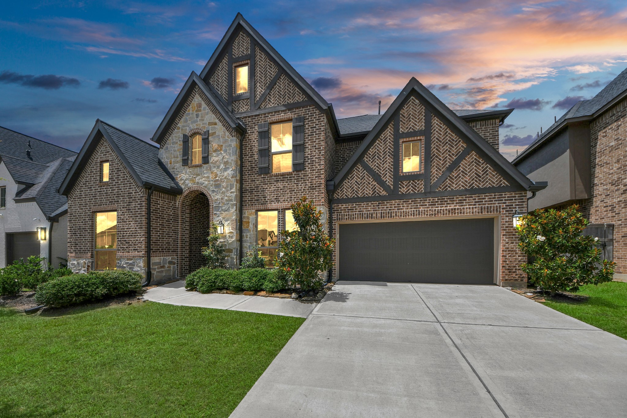 a front view of a house with a yard and garage