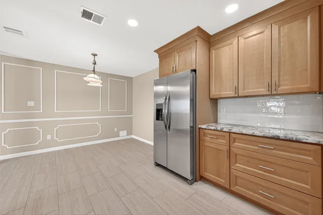 an empty room with a window and a ceiling fan