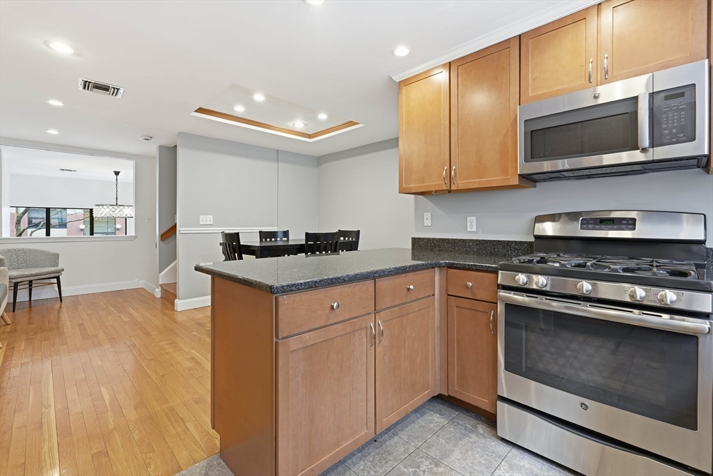 85 Brainerd Road, Unit TH7 Boston, MA 02134 - Photo 11 of 41 a kitchen with stainless steel appliances granite countertop a stove and a microwave