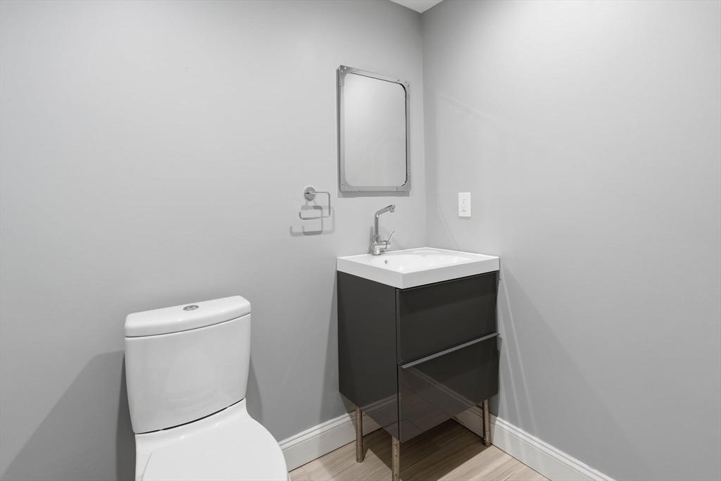85 Brainerd Road, Unit TH7 Boston, MA 02134 - Photo 14 of 41 a bathroom with a toilet sink and mirror