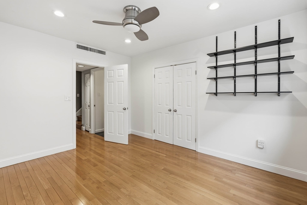 85 Brainerd Road, Unit TH7 Boston, MA 02134 - Photo 20 of 41 a view of a room with wooden floor and ceiling fan