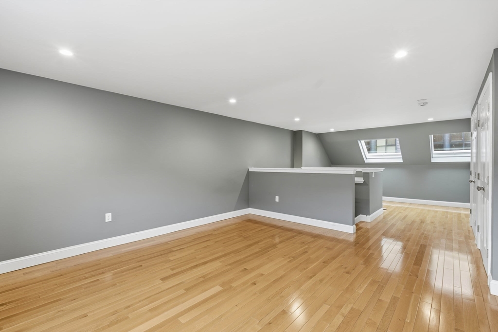 85 Brainerd Road, Unit TH7 Boston, MA 02134 - Photo 25 of 41 a view of empty room with wooden floor