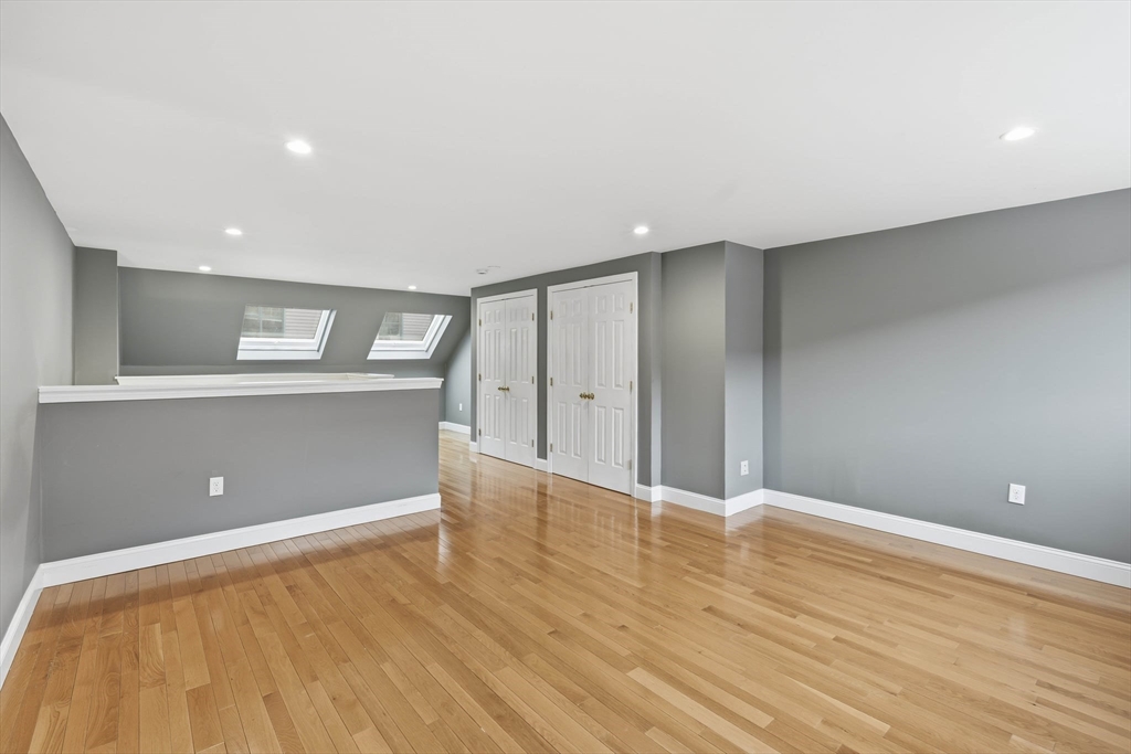 85 Brainerd Road, Unit TH7 Boston, MA 02134 - Photo 26 of 41 a view of empty room with wooden floor