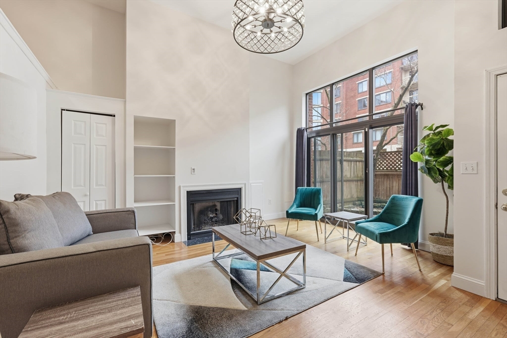 85 Brainerd Road, Unit TH7 Boston, MA 02134 - Photo 3 of 41 a living room with furniture a table and a potted plant