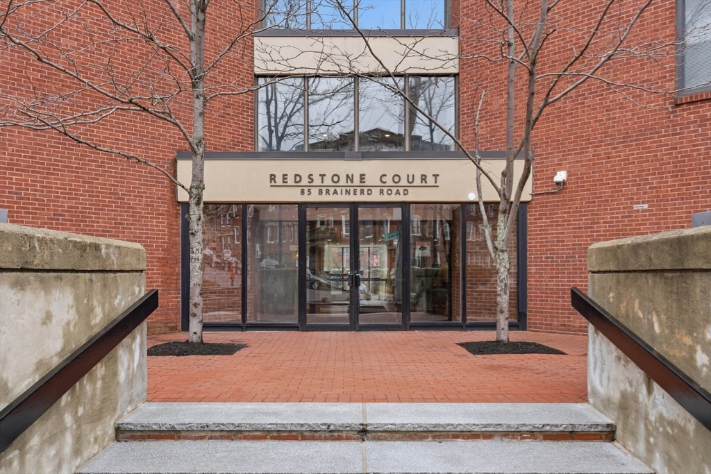 85 Brainerd Road, Unit TH7 Boston, MA 02134 - Photo 39 of 41 a view of a brick building with large windows