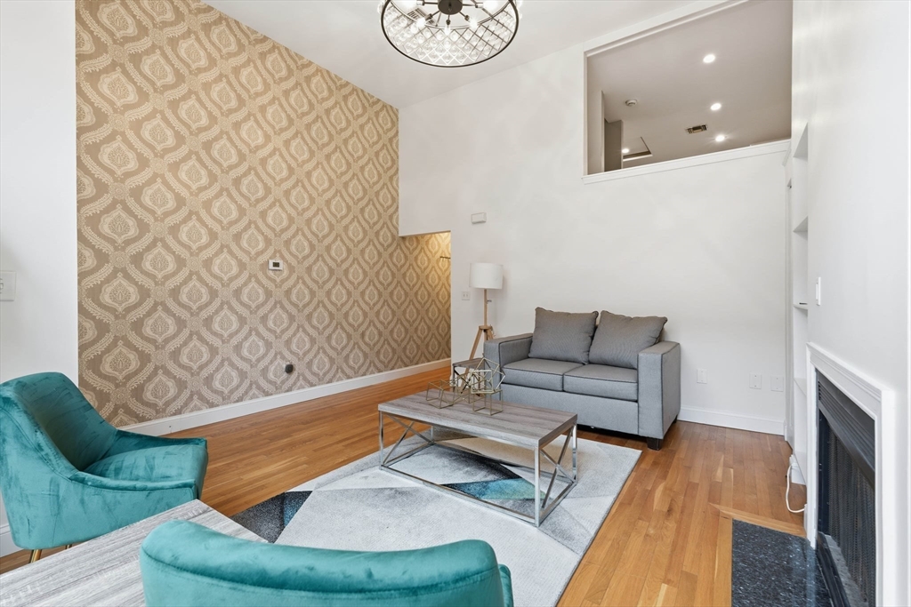 85 Brainerd Road, Unit TH7 Boston, MA 02134 - Photo 5 of 41 a living room with furniture and a fireplace