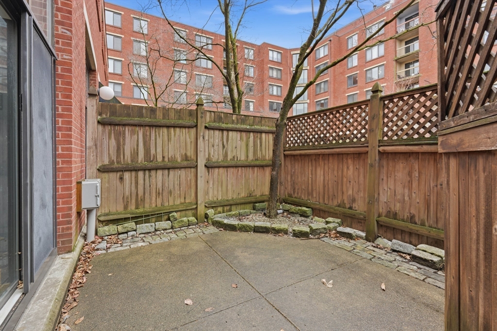 85 Brainerd Road, Unit TH7 Boston, MA 02134 - Photo 8 of 41 a view of a house with a wooden fence