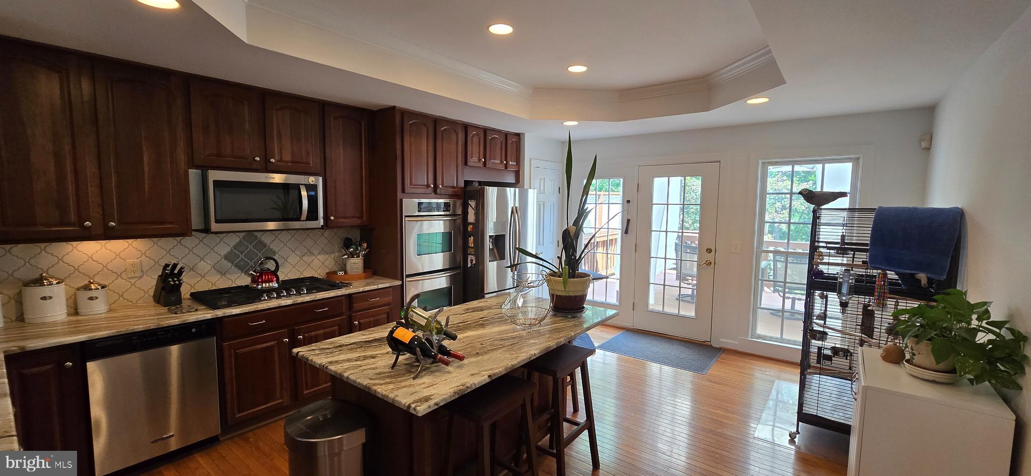 7357 Cluster House Way Gainesville, VA 20155 - Photo 11 of 28 a kitchen with sink refrigerator and microwave
