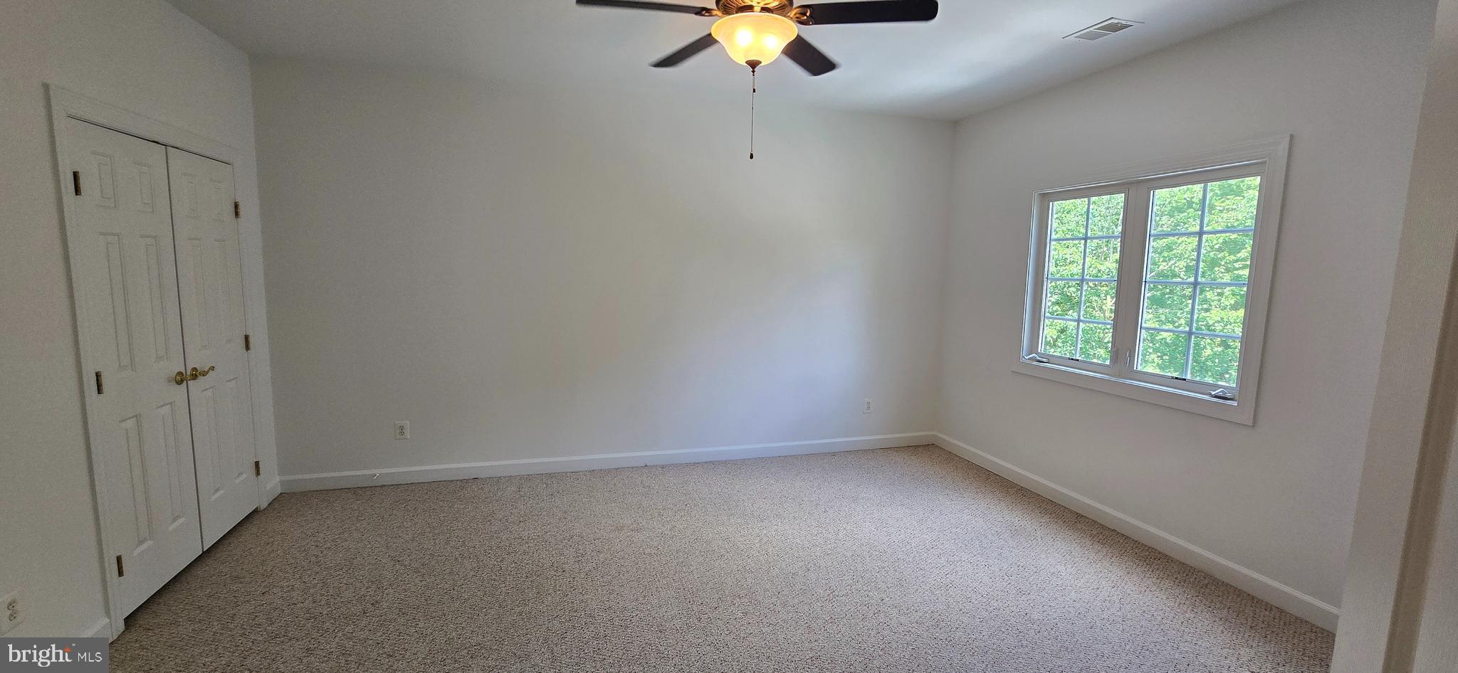 7357 Cluster House Way Gainesville, VA 20155 - Photo 21 of 28 an empty room with a window and a fan