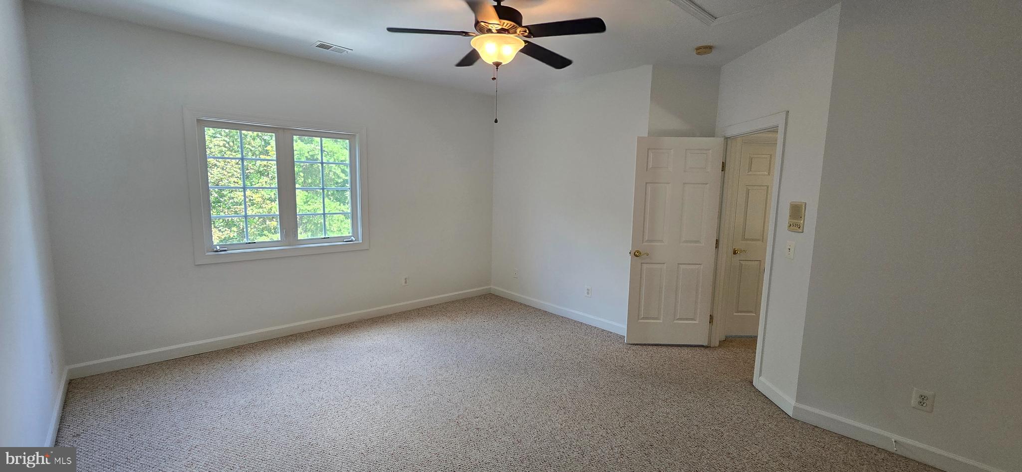 7357 Cluster House Way Gainesville, VA 20155 - Photo 22 of 28 an empty room with windows and fan