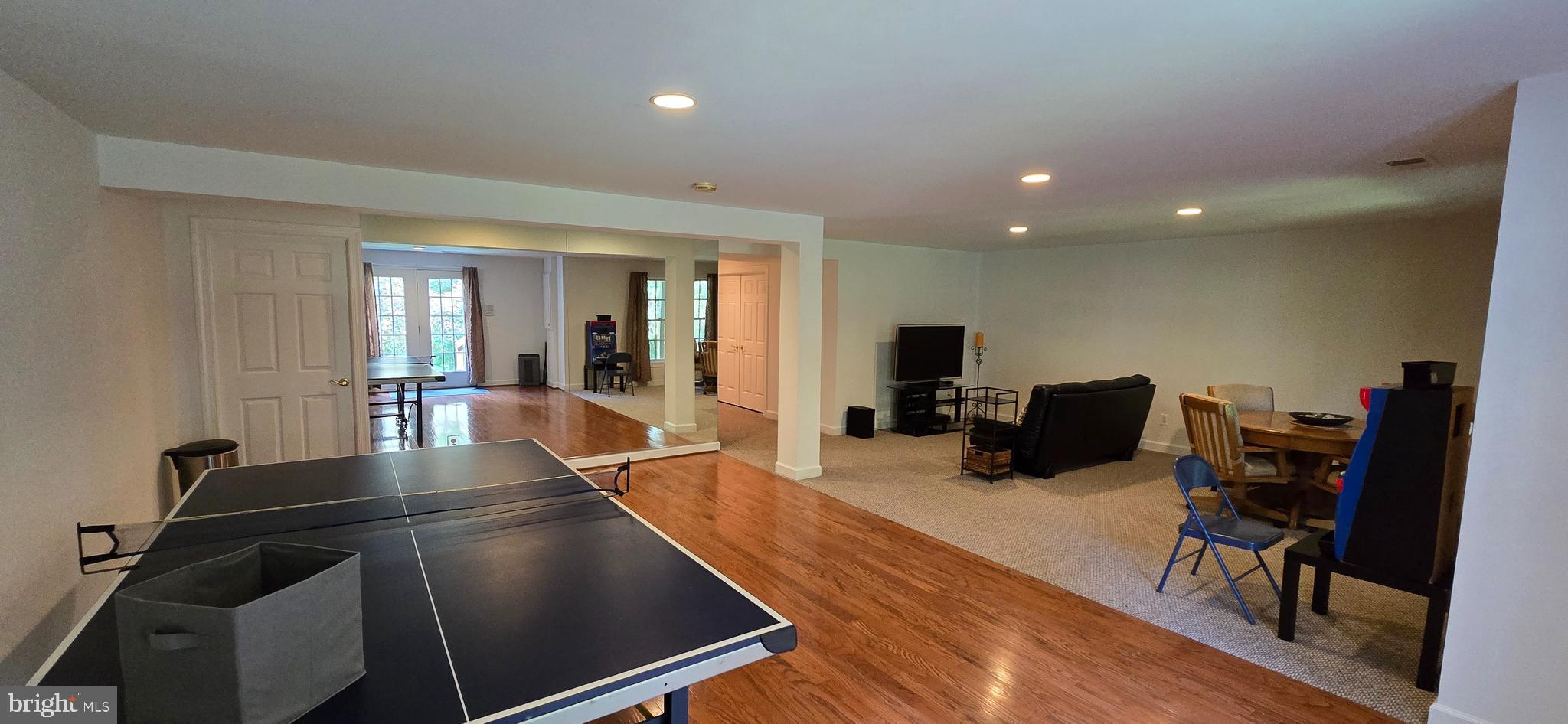 7357 Cluster House Way Gainesville, VA 20155 - Photo 28 of 28 a living room with furniture a flat screen tv and a refrigerator