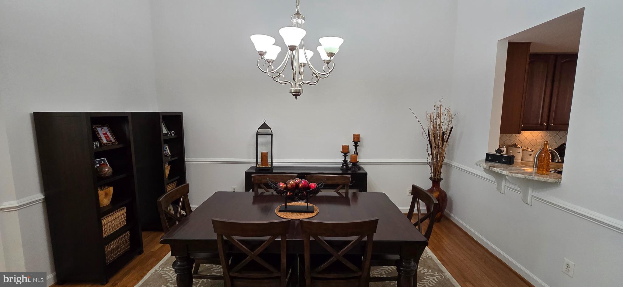 7357 Cluster House Way Gainesville, VA 20155 - Photo 7 of 28 a view of a dining room with furniture and wooden floor