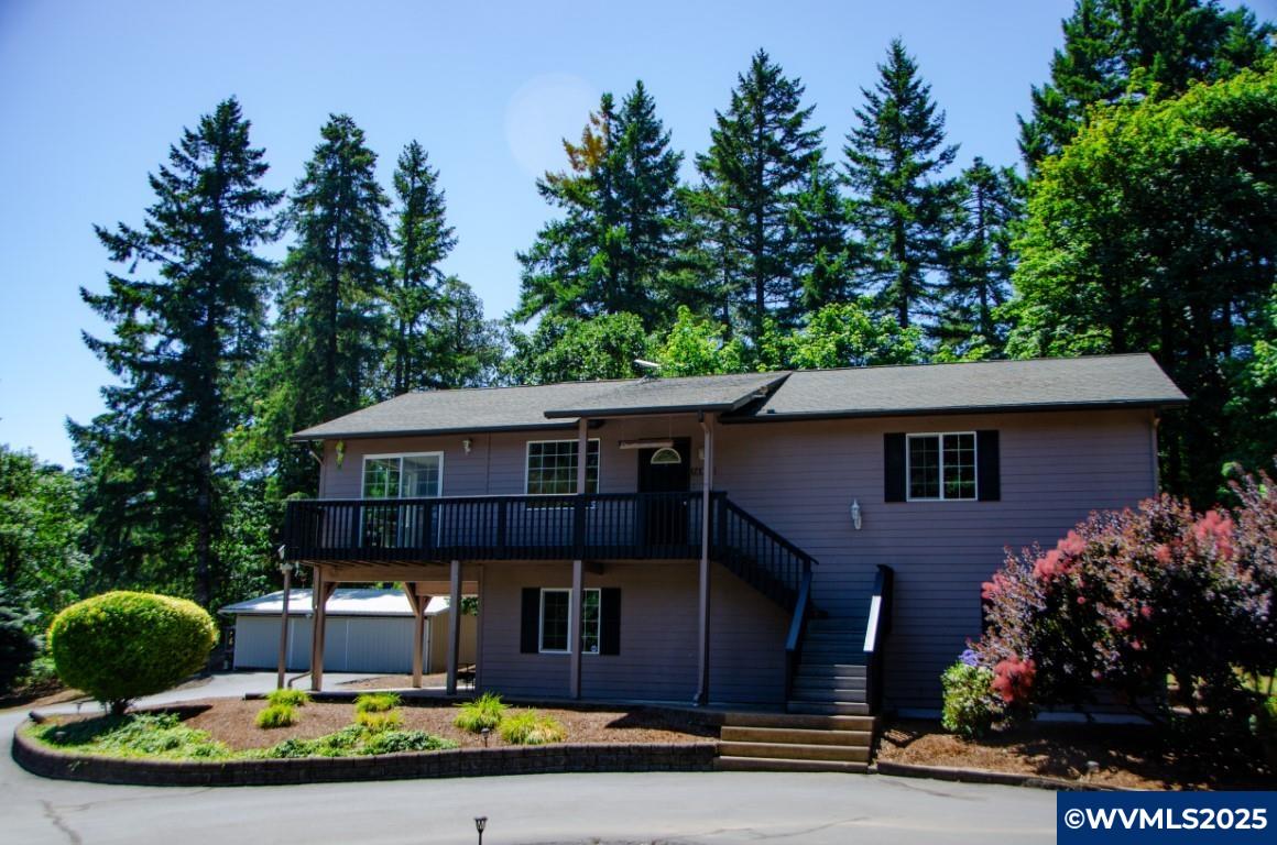 16870 Selden Road Dallas, OR 97338 - Photo 1 of 42 a front view of a house with garden