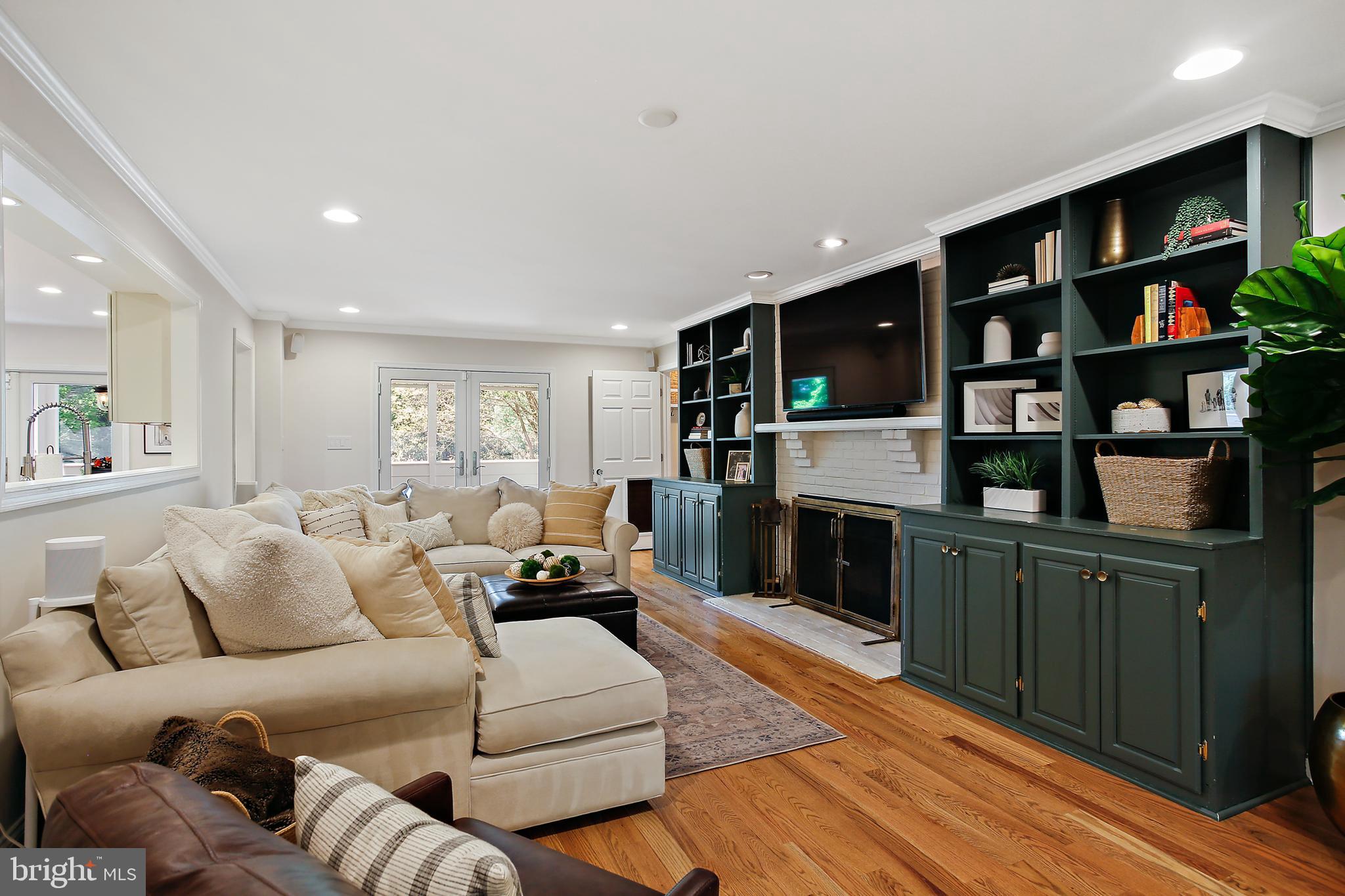 1816 Ruxton Road Baltimore, MD 21204 - Photo 25 of 92 a living room with furniture a fireplace and a book shelf