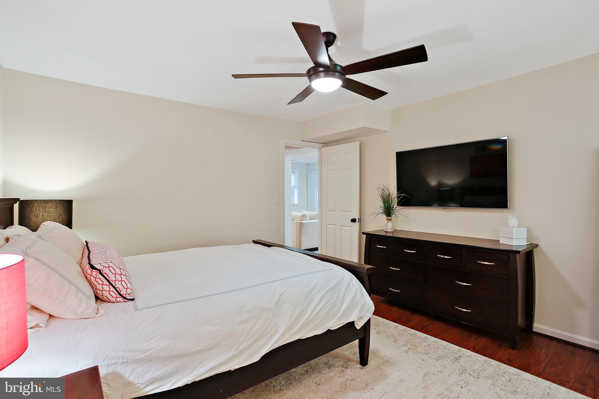 1816 Ruxton Road Baltimore, MD 21204 - Photo 56 of 92 a bedroom with a bed and a flat screen tv