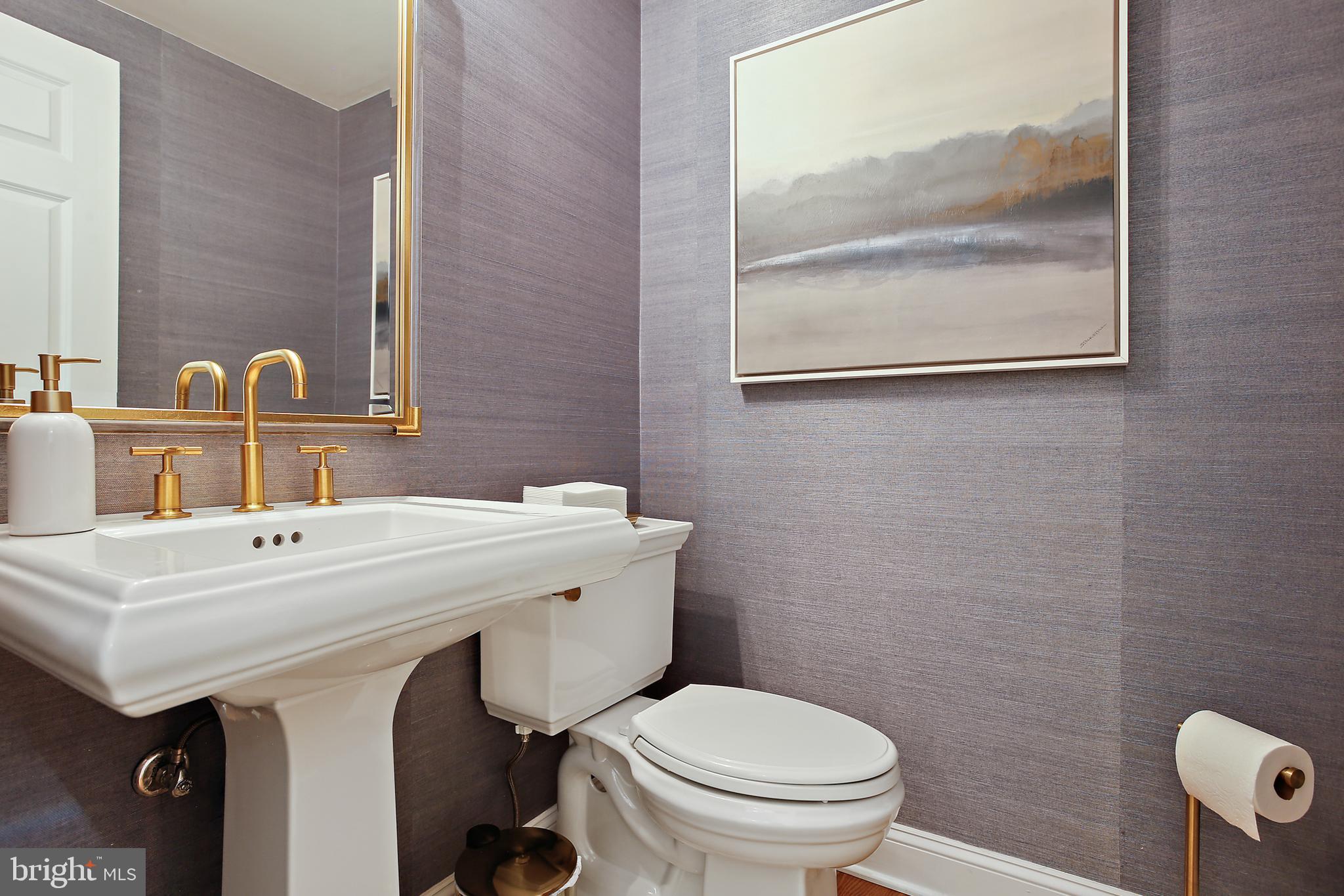 1816 Ruxton Road Baltimore, MD 21204 - Photo 9 of 92 a bathroom with a sink a toilet and a mirror