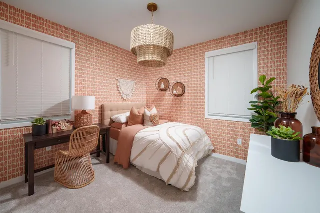 a bedroom with bed and a chandelier