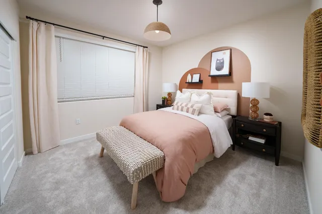 a bedroom with a bed and a chandelier