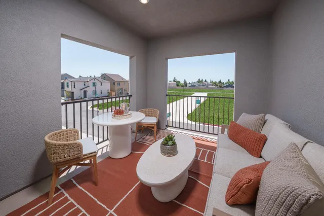 a living room with furniture and a floor to ceiling window