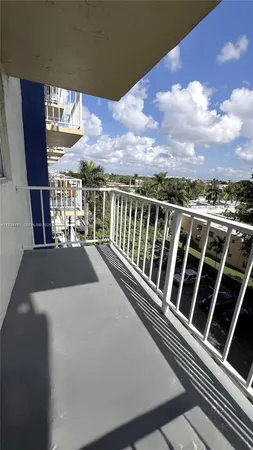a view of a balcony with wooden floor and city view
