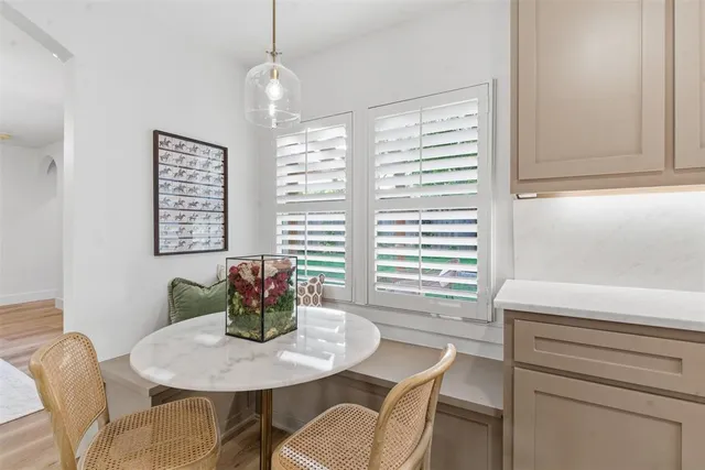 a dining room with furniture and window