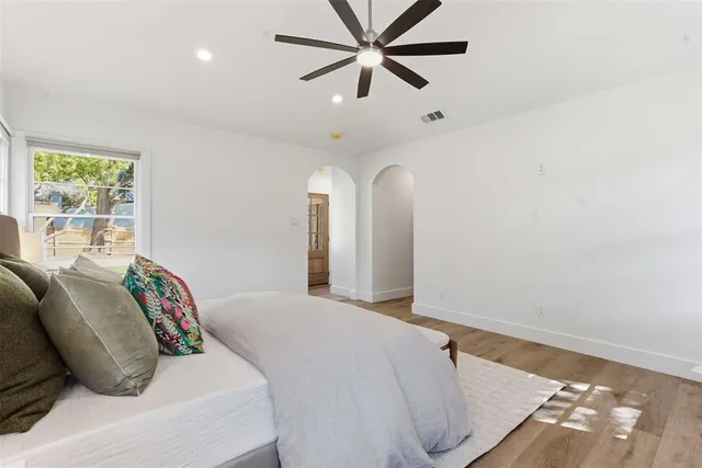 a bedroom with a bed and a window