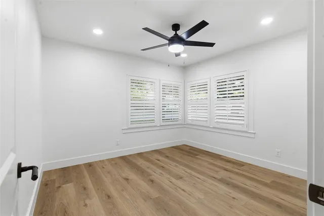 wooden floor in an empty room with a window