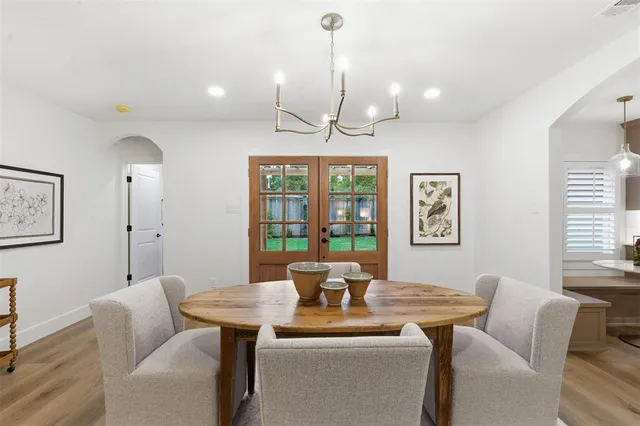 a living room with furniture a window and a chandelier