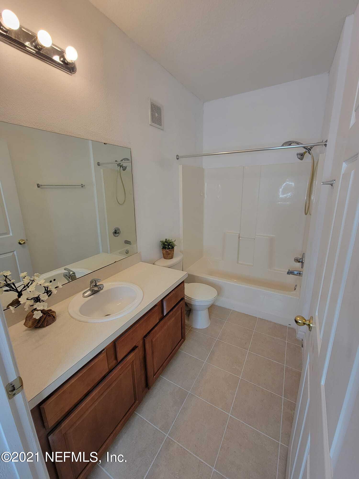 3641 Kirkpatrick Circle, Unit 4 Jacksonville, FL 32210 - Photo 12 of 17 a spacious bathroom with a sink a toilet and shower