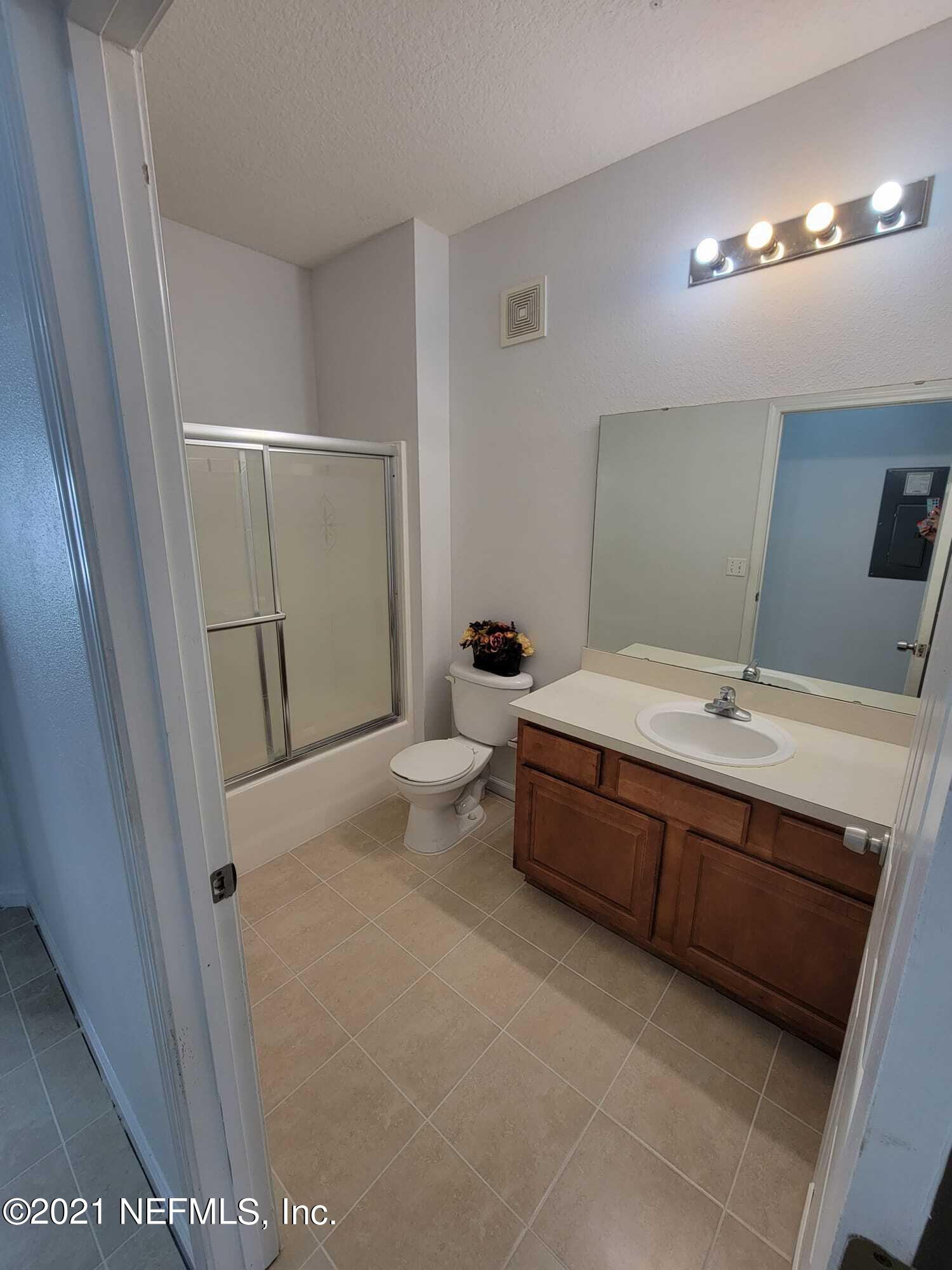 3641 Kirkpatrick Circle, Unit 4 Jacksonville, FL 32210 - Photo 14 of 17 a spacious bathroom with a tub a sink and mirror