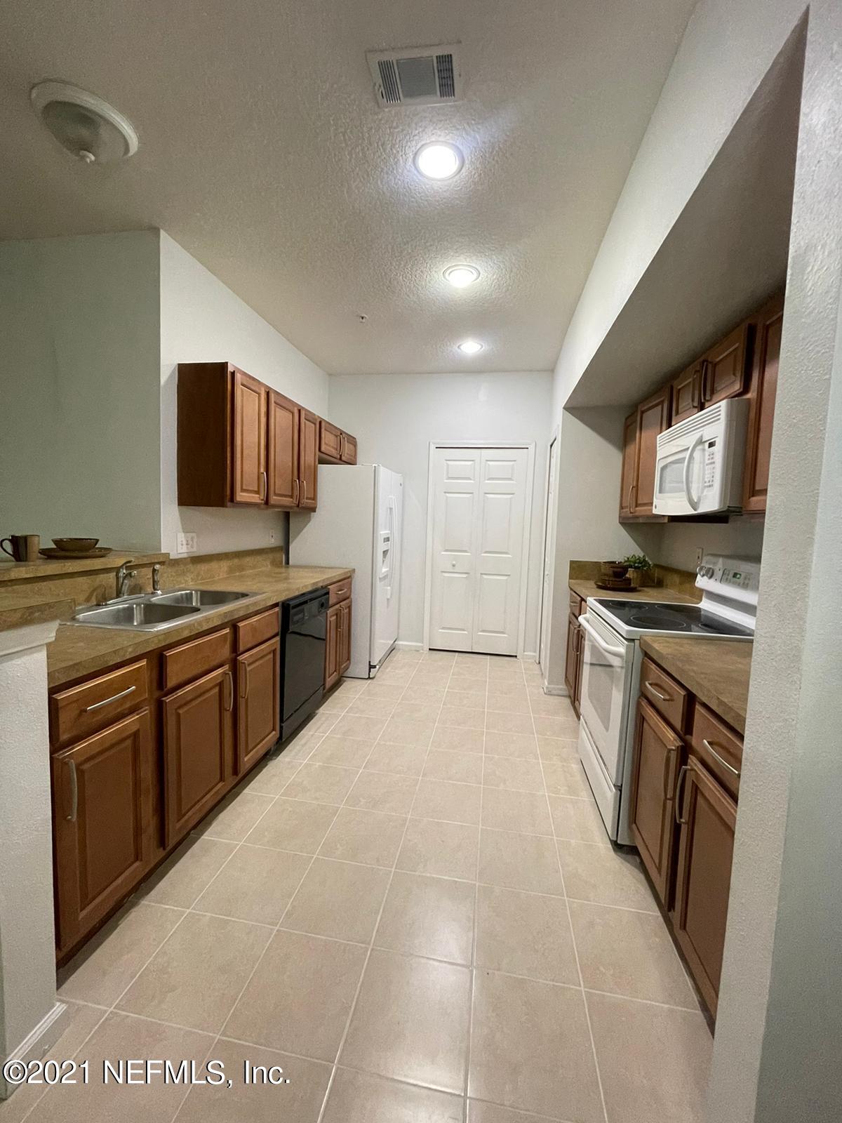 3641 Kirkpatrick Circle, Unit 4 Jacksonville, FL 32210 - Photo 5 of 17 a kitchen with stainless steel appliances granite countertop a stove top oven a sink dishwasher and a refrigerator