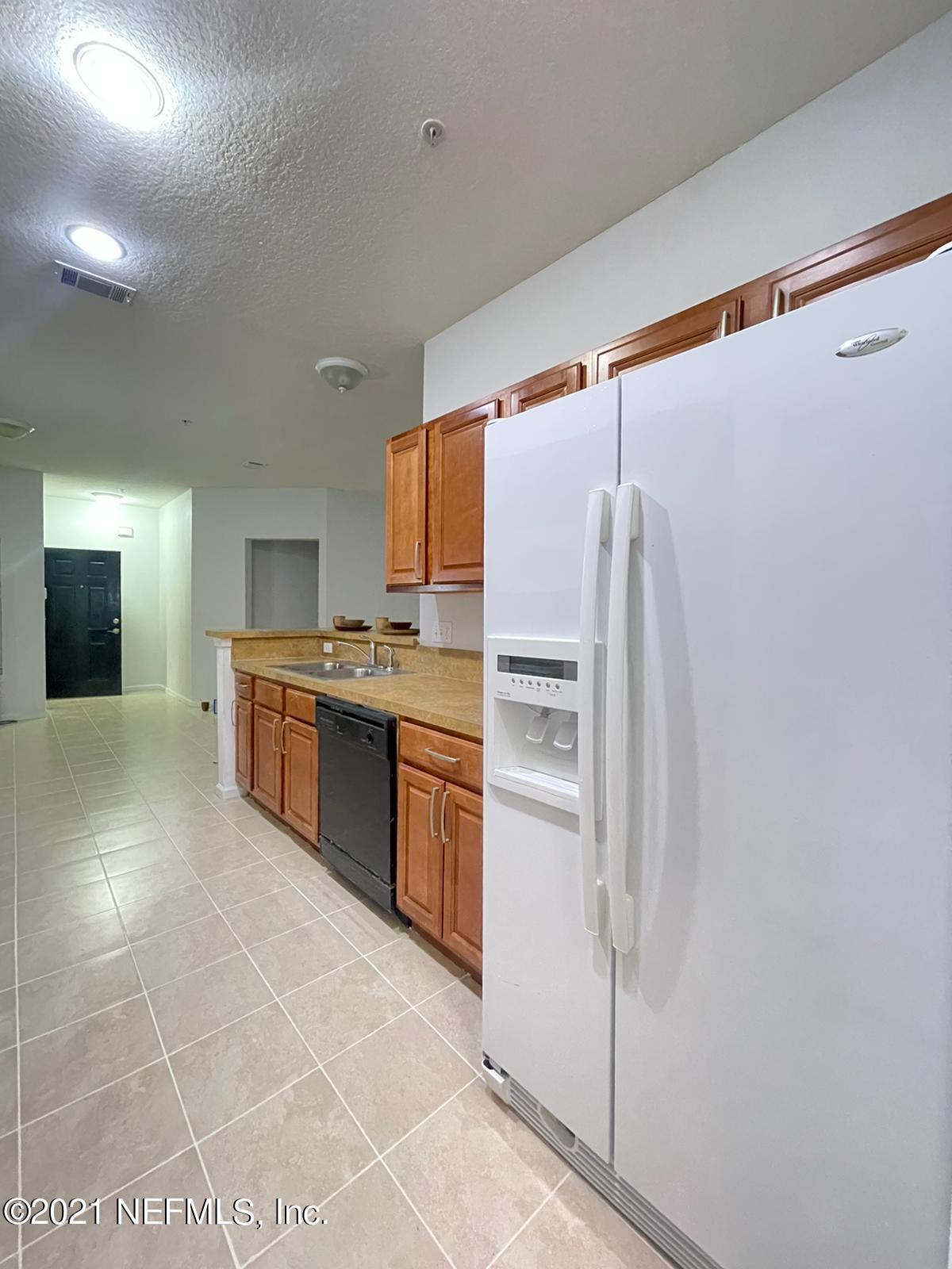 3641 Kirkpatrick Circle, Unit 4 Jacksonville, FL 32210 - Photo 6 of 17 a kitchen with granite countertop a refrigerator and a stove top oven