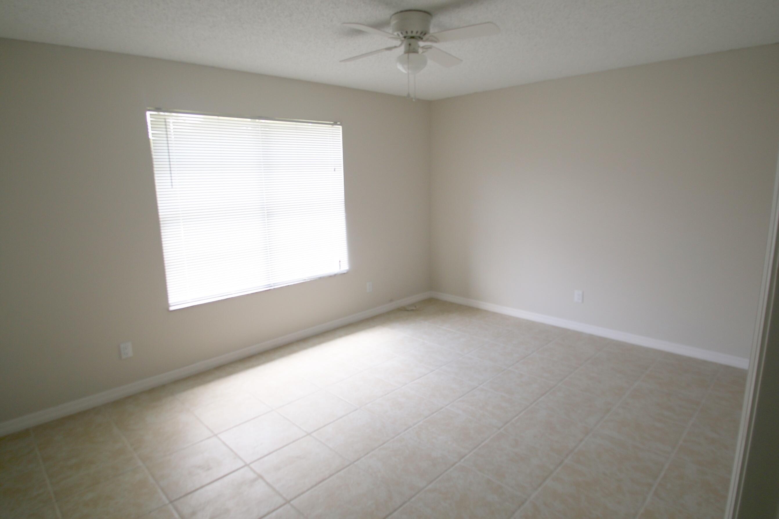 1137 Southwest Estaugh Avenue Port St. Lucie, FL 34953 - Photo 8 of 11 an empty room with a window