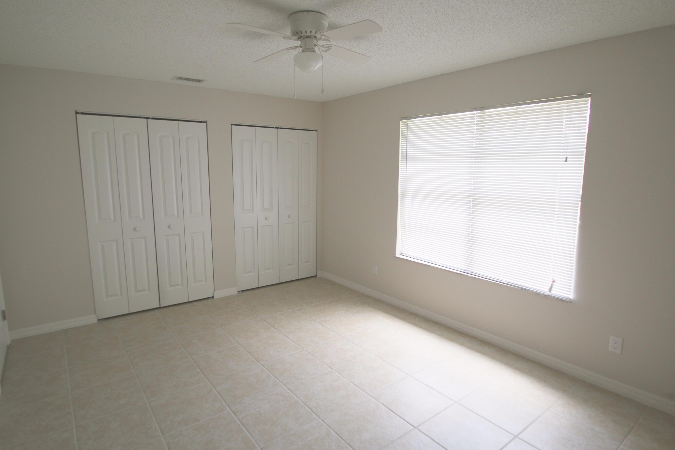 1137 Southwest Estaugh Avenue Port St. Lucie, FL 34953 - Photo 9 of 11 an empty room with a window