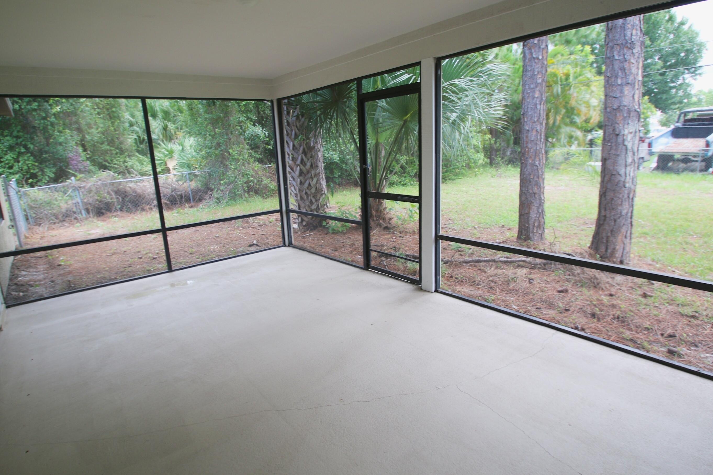 1137 Southwest Estaugh Avenue Port St. Lucie, FL 34953 - Photo 10 of 11 a view of empty room with sliding window