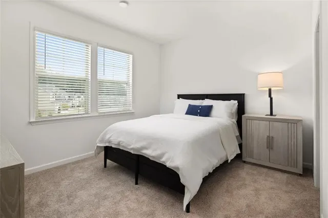 a bedroom with a bed and a night stand