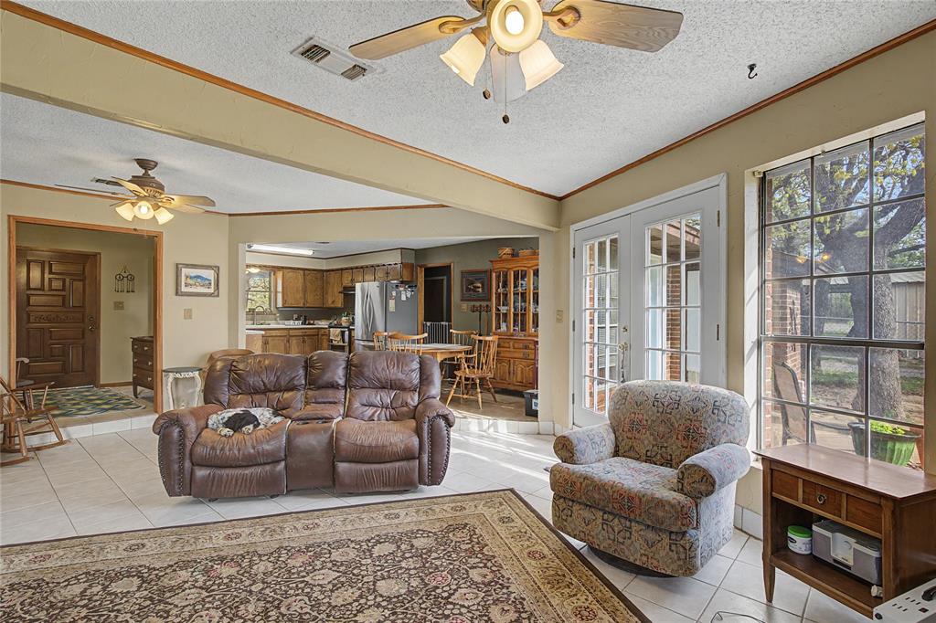 243 County Road 3851 Poolville, TX 76487 - Photo 9 of 34 a living room with furniture and a large window