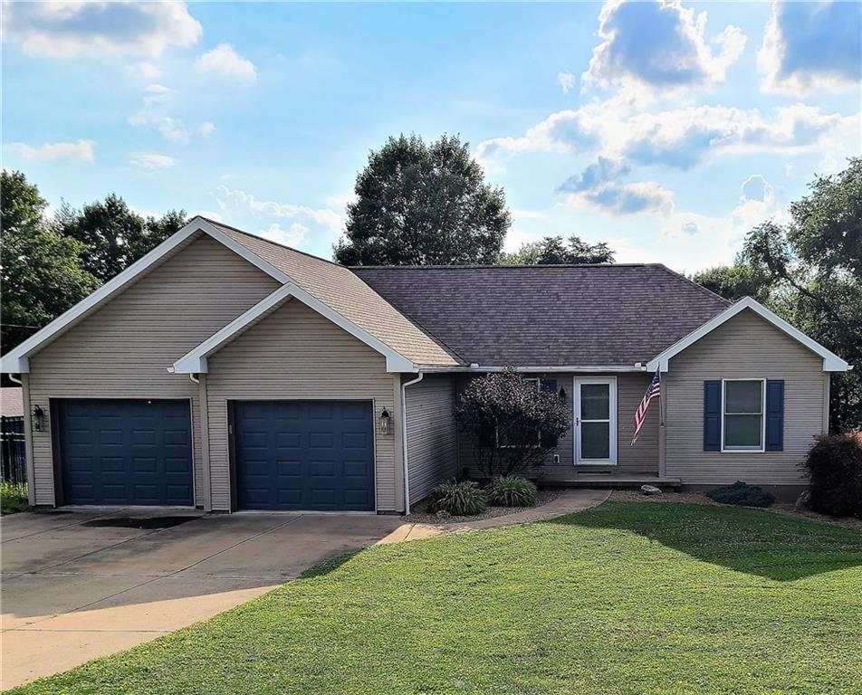 a front view of a house with a garden and yard
