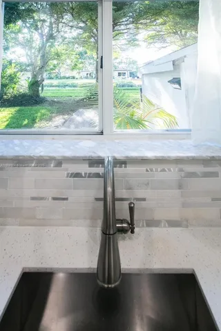 a view of a floor to ceiling window and a wooden floor